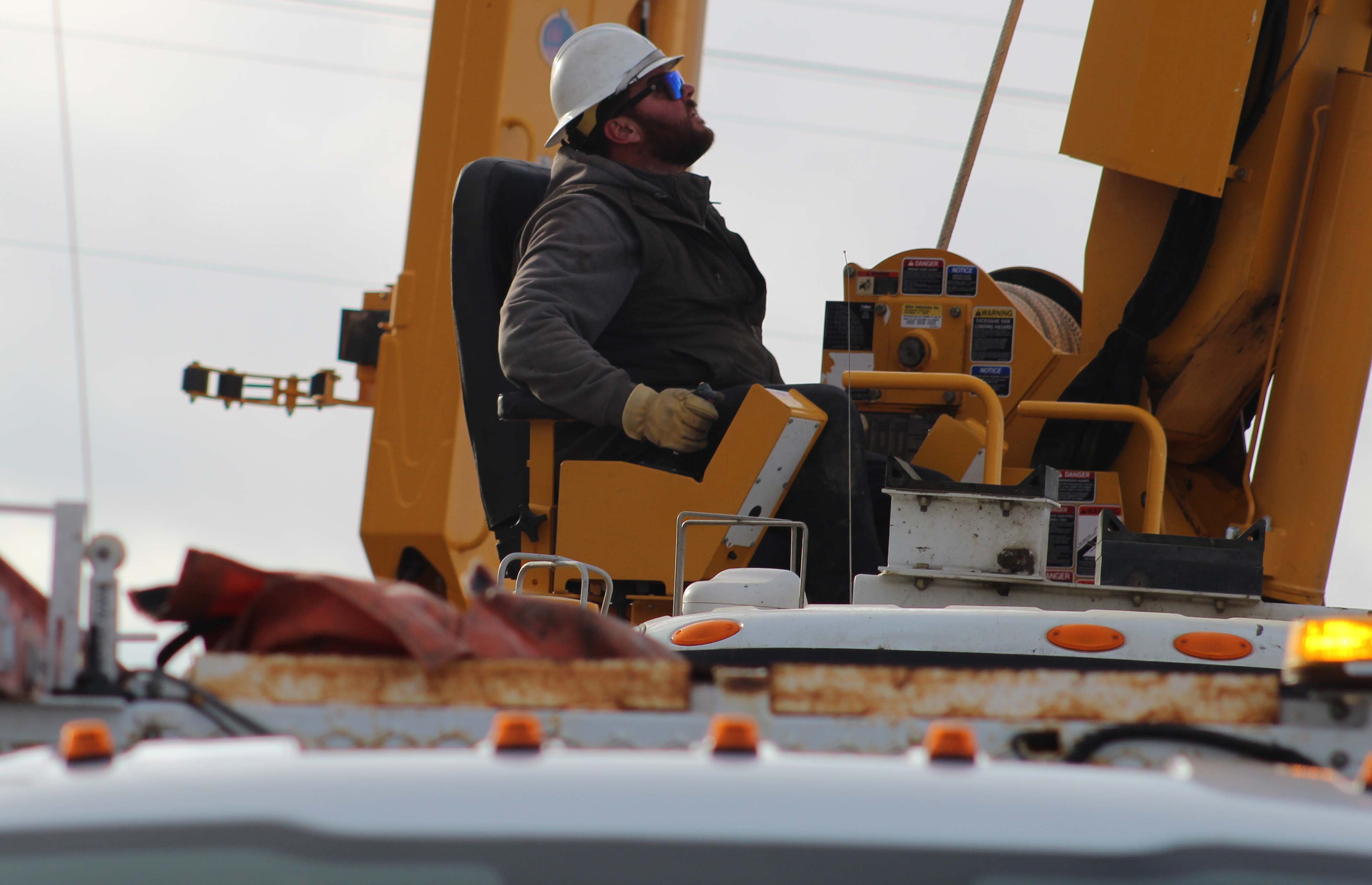 Lineman operating boom on vehicle