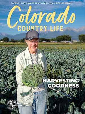 Cover photo for April 2025 Colorado Country Life featuring a man and an agility dog
