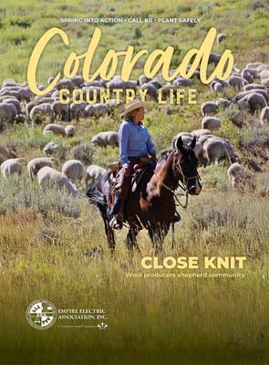 April 2026 EEA Colorado Country Life cover photo pf a woman riding in a meadow herding sheep