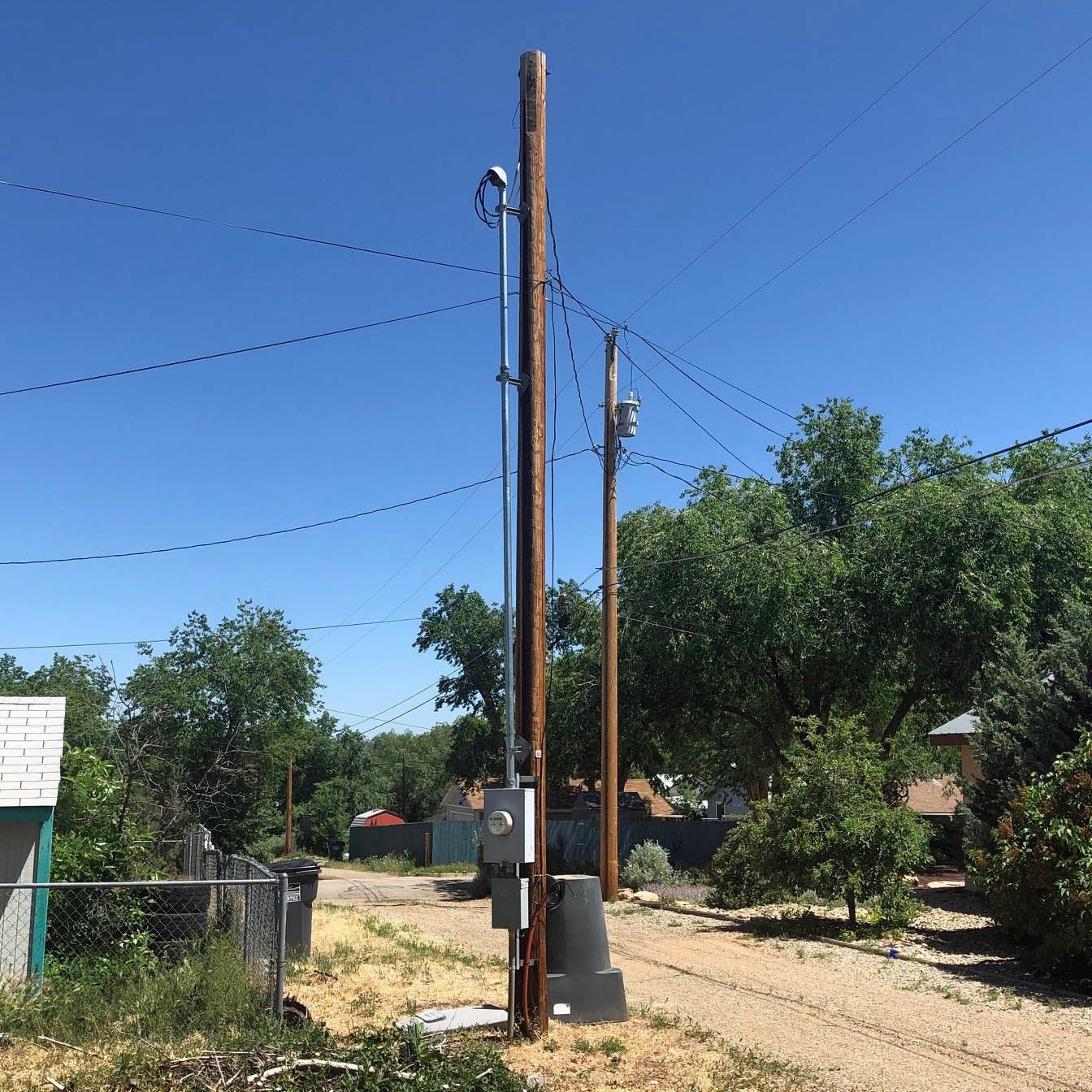electric meter on a pole in an alley